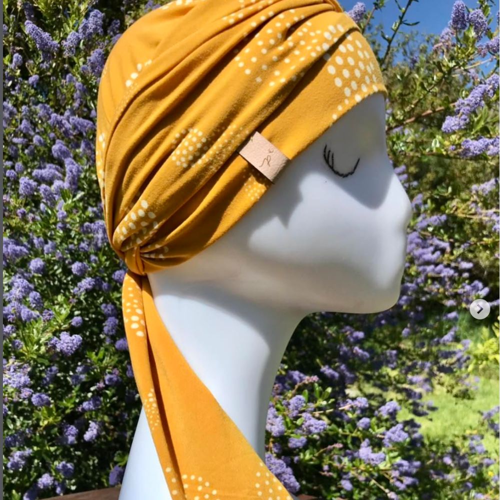 Turbante mostaza con lunares blancos y lazo lateral